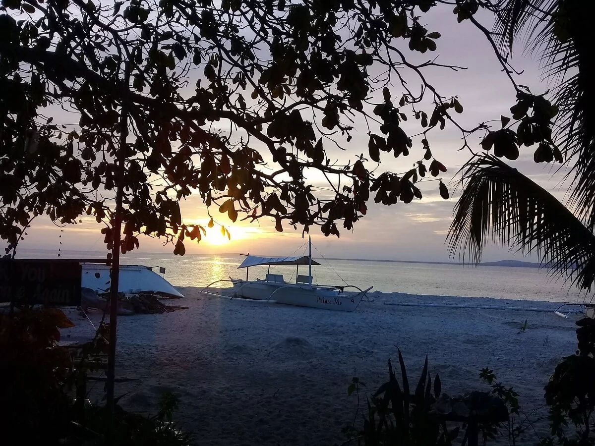 Honeymoon couple is enjoying the amazing sunset on Pamilacan Island